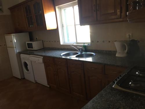 a kitchen with a sink and a counter top at Holiday villa with pool near the ocean in Aljezur