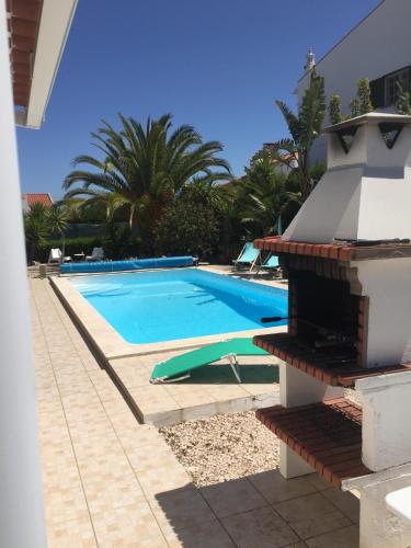 a swimming pool in front of a villa at Holiday villa with pool near the ocean in Aljezur