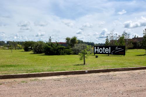 a hotel sign on the side of a field at Hotel Juana de Ibarbourou in Melo