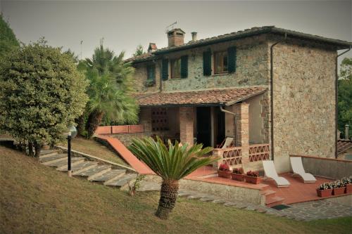 una casa con una palmera delante de ella en Casa delle Palme, en Monsagrati