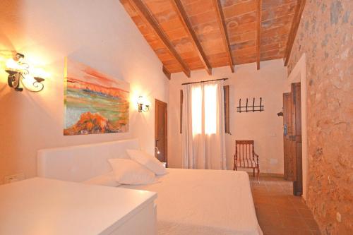 a bedroom with a bed and a room with a window at Villa Alba in Llubí