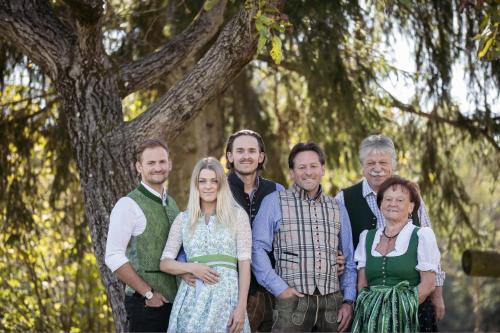 a group of people standing in front of a tree at Landhof Lazarus in Mooskirchen