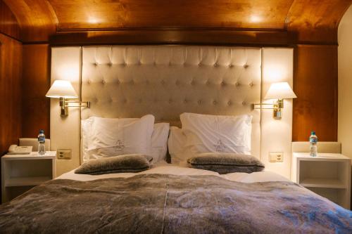 a bedroom with a large bed with two pillows at Boutique Hotel Albana Real - Restaurants & Spa in Zermatt