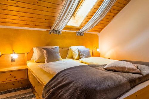 a bedroom with two beds and a skylight at Urbangut in Sankt Michael im Lungau