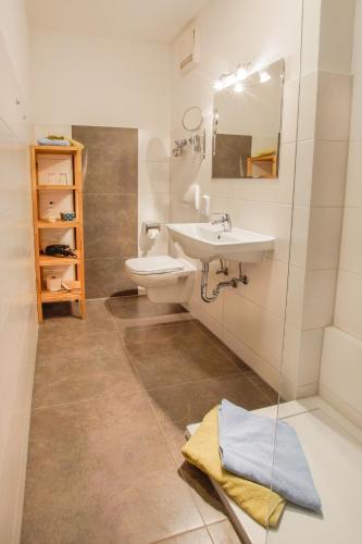 a bathroom with a sink and a toilet at Haus Sylta in Fischen