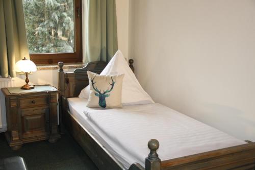 a bedroom with a bed with a pillow on it at Landhaus Am Westerwald in Martinfeld