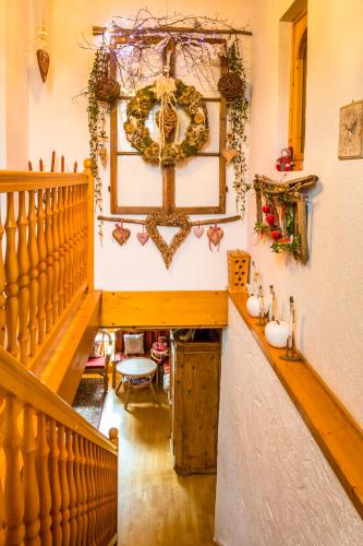 a room with a staircase and a wreath on the wall at Urbangut in Sankt Michael im Lungau