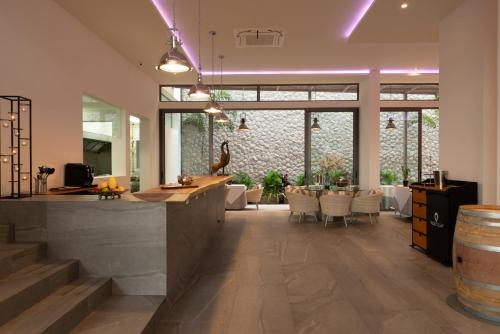 a tasting room with a bar and a table and chairs at Patong Heights in Patong Beach