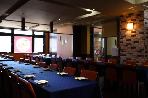 a conference room with a long table and chairs at Hotel Wing International Chitose in Chitose