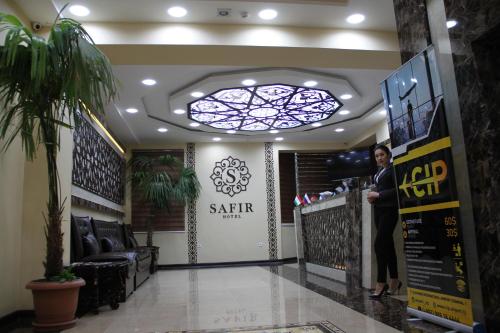 a woman standing at the counter of a salon at SAFIR BUSINESS HOTEL o in Dushanbe