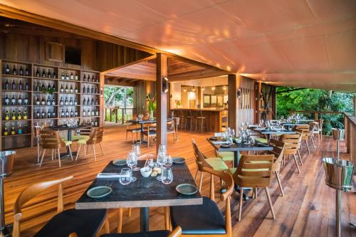 a restaurant with tables and chairs and wine bottles at Secret Bay in Portsmouth