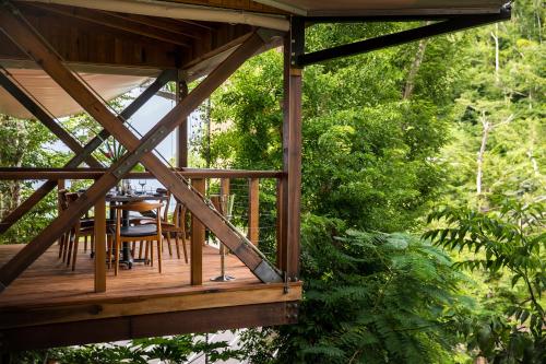 a wooden deck with a table and chairs on it at Secret Bay in Portsmouth