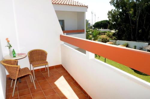 a balcony with a table and chairs and a view at Hotel Pradillo Conil in Conil de la Frontera