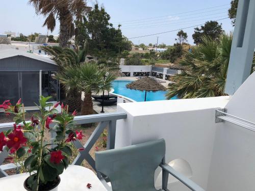 a balcony with a view of a swimming pool at Black Coast Santorini in Perivolos
