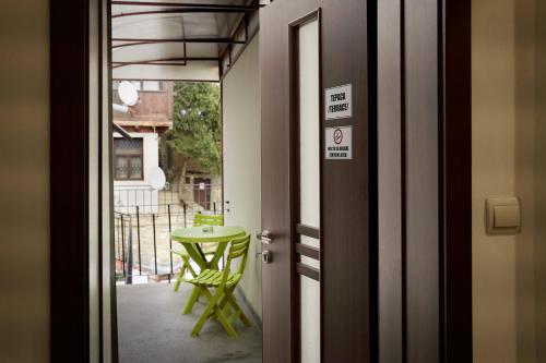 a door leading to a room with a green table at Guest Rooms Tsarevets in Veliko Tŭrnovo