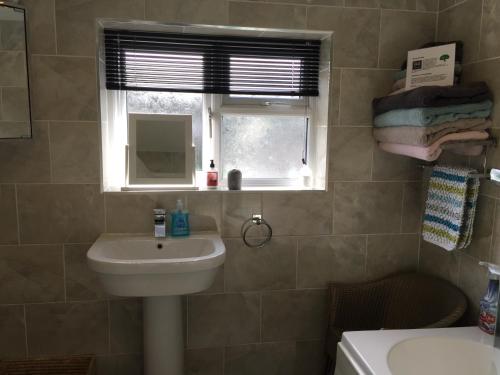 a bathroom with a sink and a window at 94 High Street in Cross Hands