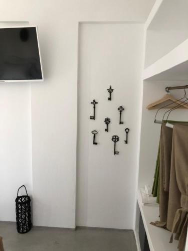 a white wall with black crosses on it at Black Coast Santorini in Perivolos