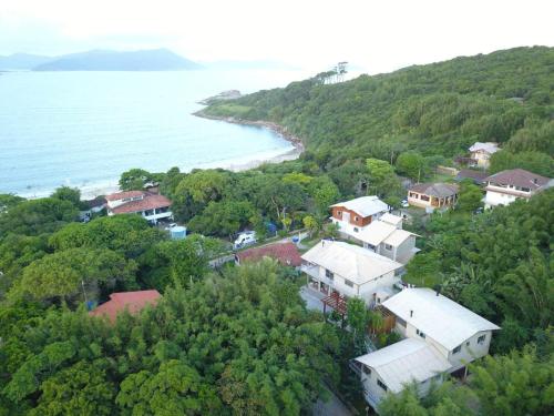 an aerial view of a village next to the ocean at Residencial Vô Joca in Palhoça