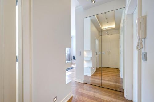 a hallway with a large mirror in a room at Stylish Apartment in Heart of Oldtown in Gdańsk