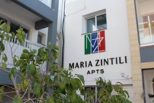 a sign for a maria zinnia institutes at a building at Maria Zintili Apartments in Ayia Napa