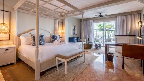 a bedroom with a bed and a desk and a desk at Be Live Collection Punta Cana Adults Only in Punta Cana