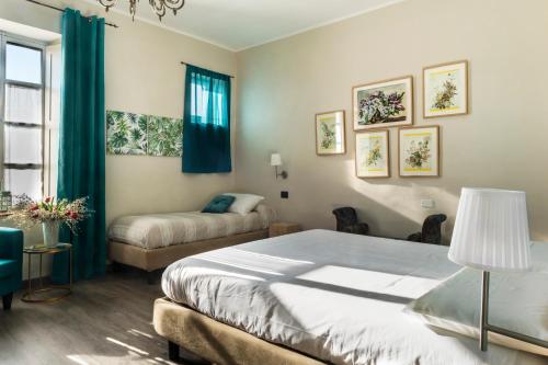 a bedroom with a bed and a couch and a window at Ca'diFra in Casalborgone