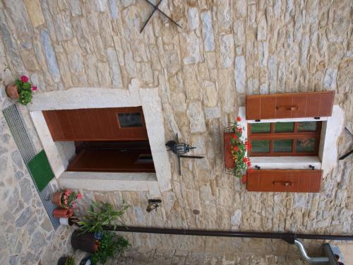 an overhead view of a stone building with a window at al Merlo Olivo, rural istrian house in Buje