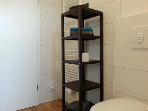a black towel rack in a bathroom with a toilet at Ferienhäuser im Ferienhausgebiet Hof Beel in Oberlangen