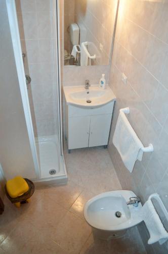 a bathroom with a toilet and a sink and a shower at Il Sogno di una Stella in Alghero