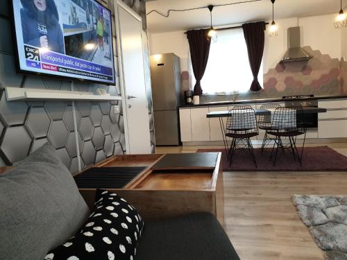 a living room with a couch and a table at VillaGrey Tunari in Tunari
