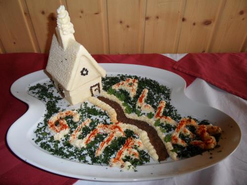 a cake on a plate with a house on it at Landhotel Weisses Röß`l in Adorf