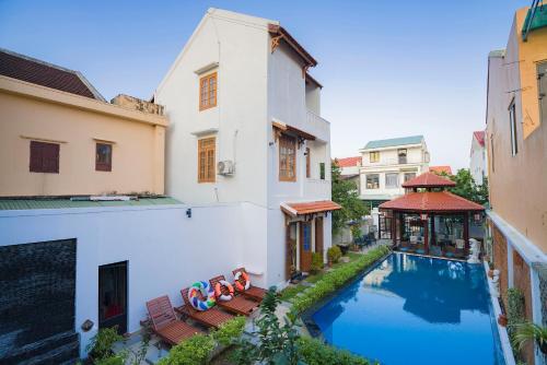 a swimming pool in the middle of a building at Green Grapefruit Villa in Hoi An