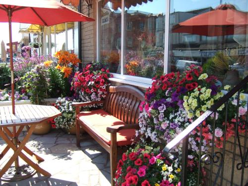 a bench sitting in front of a flower shop at Granville Hotel in Blackpool