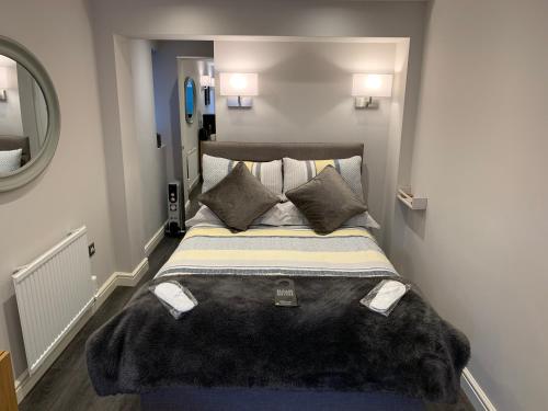 a bedroom with a large bed with a large blanket at The Ashfield in Sutton in Ashfield