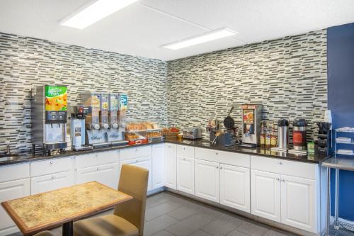 a coffee shop with a counter and a table at Travelodge by Wyndham Savannah Area/Richmond Hill in Richmond Hill