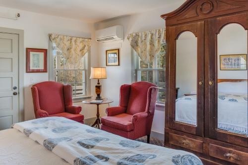 a bedroom with two chairs and a bed at First Colony Inn in Nags Head