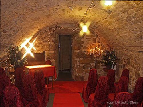 a room with a stage and chairs in a cave at Clennell Hall Country House - Near Rothbury - Northumberland in Alwinton