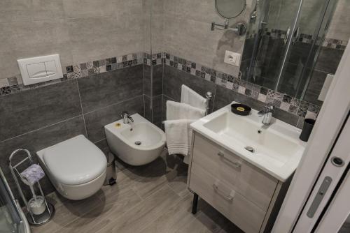 a bathroom with a toilet and a sink at B&B Elegance in Taormina
