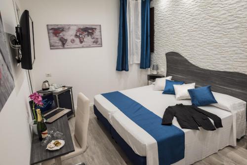 a bedroom with a large bed with blue pillows at B&B Elegance in Taormina