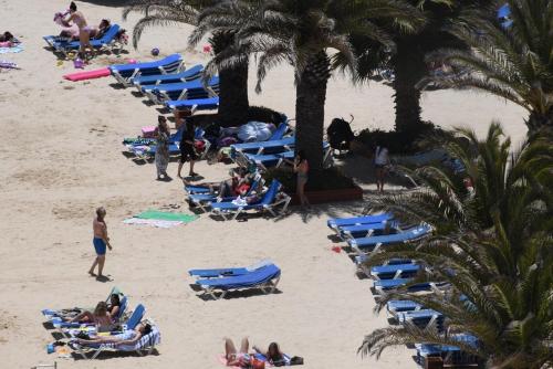 a group of people laying in chairs on a beach at Condominio San Alfonso Del Mar - Vista Inmejorable in Algarrobo