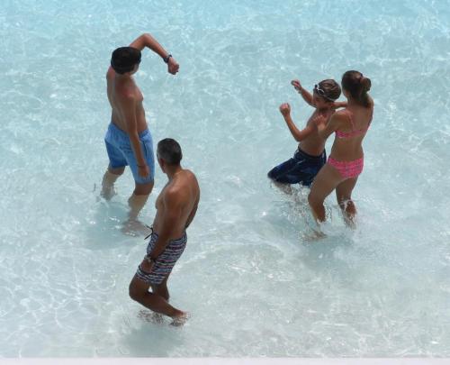 a group of people standing in the water at the beach at Condominio San Alfonso Del Mar - Vista Inmejorable in Algarrobo