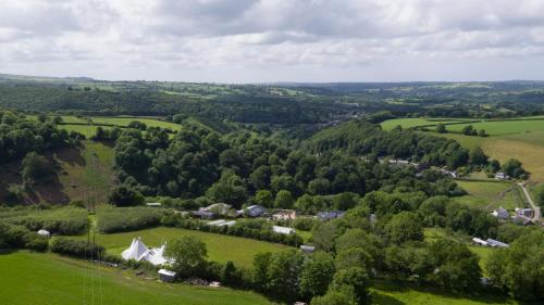 
A bird's-eye view of Ceridwen Glamping, double decker bus and Yurts
