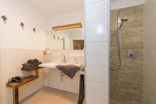 a bathroom with a sink and a shower at Bio-Bergbauernhof Hubgut in Zell am See