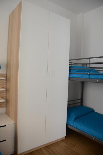 a bedroom with two bunk beds and a closet at Blue Sea Apartment in Torre Canne