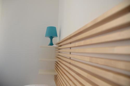 a green lamp sitting on a shelf next to a window at Blue Sea Apartment in Torre Canne