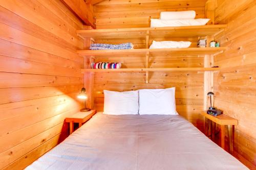 a bedroom with a bed in a log cabin at Escape to Oceanside in Oceanside