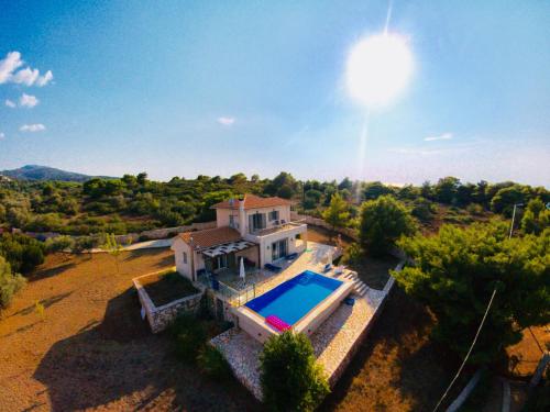 an aerial view of a house with a swimming pool at Villa Thalea in Tsoukaladhes