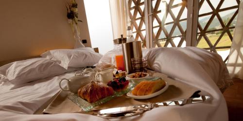 a tray of food on top of a bed at Locanda Sant'Agata in San Giuliano Terme