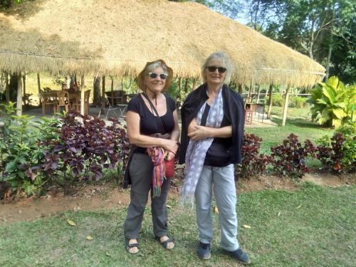 two women standing next to each other under an umbrella at Edgestay in Mudigere