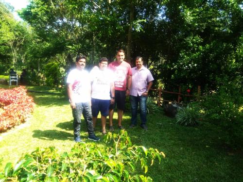 a group of men posing for a picture in a yard at Edgestay in Mudigere